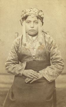 Three-quarters length portrait of a woman, seated, facing front, between 1870 and 1886. Creator: Unknown