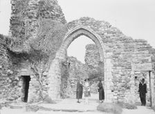 Three women and a man standing in front of ruins, between 1911 and 1942. Creator: Arnold Genthe