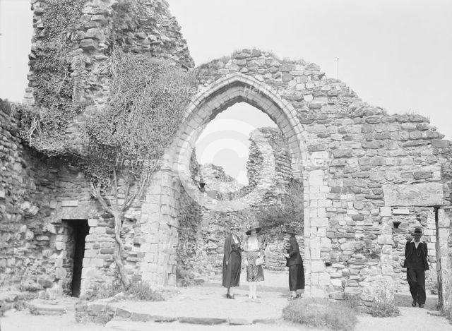 Three women and a man standing in front of ruins, between 1911 and 1942. Creator: Arnold Genthe.