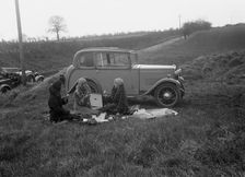Three women having a picnic during a road test of a Triumph Scorpion, 1931. Artist: Bill Brunell