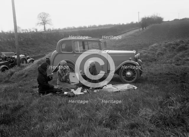 Three women having a picnic during a road test of a Triumph Scorpion, 1931. Artist: Bill Brunell.