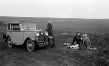 Three women having a picnic during a road test of a Triumph Scorpion, 1931. Artist: Bill Brunell