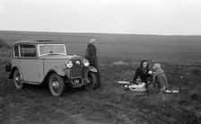 Three women having a picnic during a road test of a Triumph Scorpion, 1931. Artist: Bill Brunell