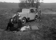 Three women having a picnic during a road test of a Triumph Scorpion, 1931. Artist: Bill Brunell