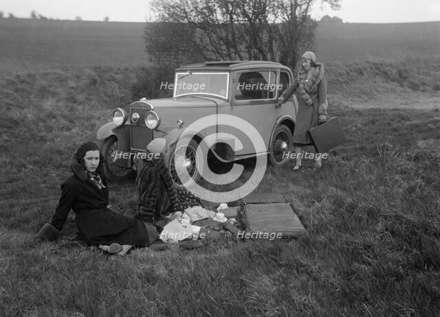 Three women having a picnic during a road test of a Triumph Scorpion, 1931. Artist: Bill Brunell.