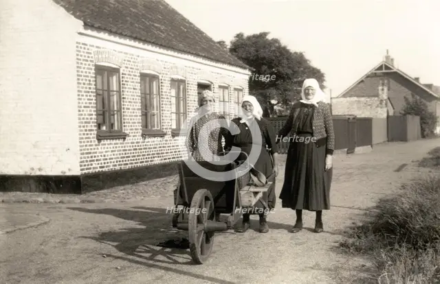 Three women on their way to town to sell fish their husbands have caught, Landskrona, Sweden. Creator: Unknown.