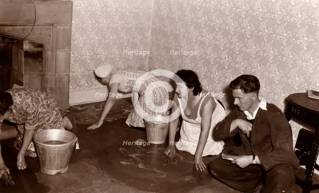 Three women scrub a stone floor on their hands and knees, 1956. Artist: Unknown