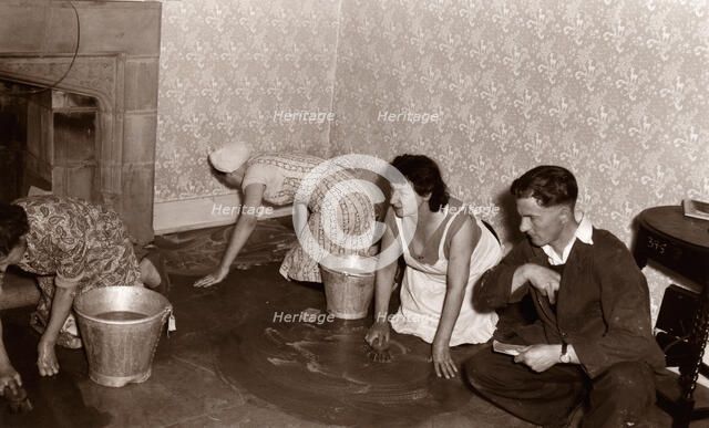 Three women scrub a stone floor on their hands and knees, 1956. Artist: Unknown