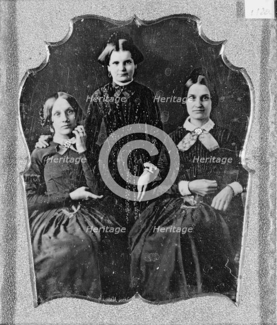 Three unidentified women, two seated, one standing, facing front, between 1840 and 1860. Creator: Unknown.