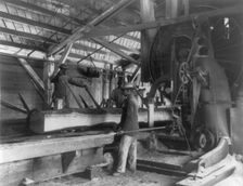 Three young black men working in lumber mill at Hampton Institute, Hampton, Va., 1899 or 1900. Creator: Frances Benjamin Johnston