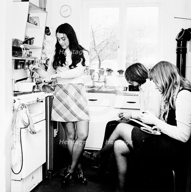 Three young people in the kitchen of a London flat, c1960s. Creator: Henry Grant.