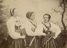 Three young women dressed in costumes from Leksand, Dalarna, 1886-1920. Creator: Helene Edlund