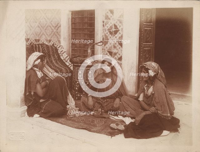Three young women sitting by a doorway, Tunis, c1910. Ernst Heinrich Landrock, (1878-1966) Creator: Lehnert & Landrock.