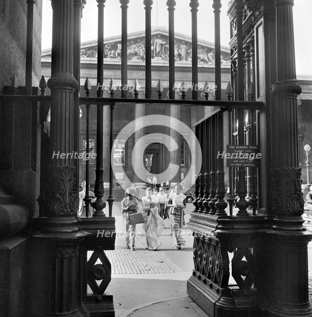 Three young women walk towards the exit gateway of the British Museum, Camden, London, c1946-c1959. Artist: John Gay