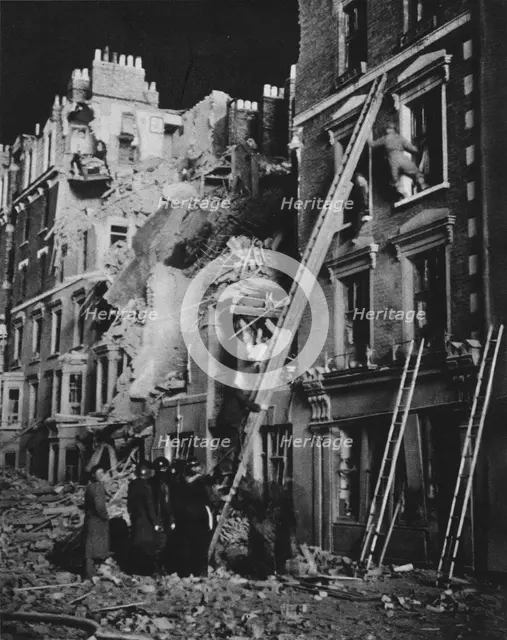 'Through the long night the rescue men at work, searching, helping to safety', 1941 (1942). Artist: Unknown.