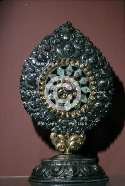 Tibetan Wheel of the Law inlaid with turquoise and coral. Artist: Unknown.