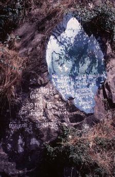 Tibetan script painted on rocks, Dharamsala, India, 1988. Creator: Amanda Waite