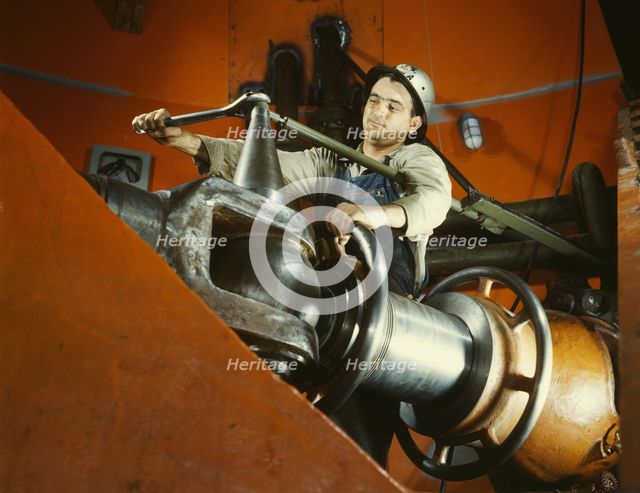 Tightening a nut on a guide vane operating seromotor in TVA's..., Watts Bar Dam, Tennessee, 1942. Creator: Alfred T Palmer.