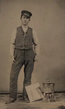Tinsmith with Coal Heater and Sheet of Tin, 1870s-80s. Creator: Unknown