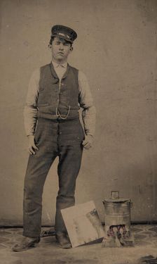 Tinsmith with Coal Heater and Sheet of Tin, 1870s-80s. Creator: Unknown