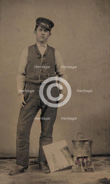 Tinsmith with Coal Heater and Sheet of Tin, 1870s-80s. Creator: Unknown.