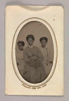 Tintype in a paper case of three unidentified young women seated, 1870s. Creator: Unknown