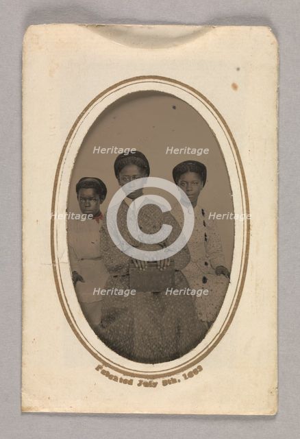 Tintype in a paper case of three unidentified young women seated, 1870s. Creator: Unknown.