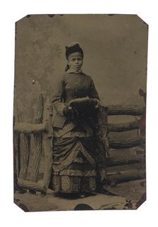 Tintype of woman in jacket and dress with hat and muff, 1880s. Creator: Unknown