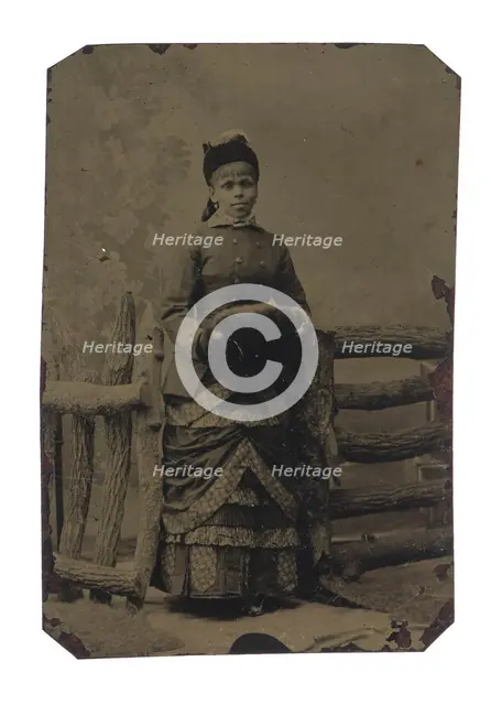 Tintype of woman in jacket and dress with hat and muff, 1880s. Creator: Unknown.