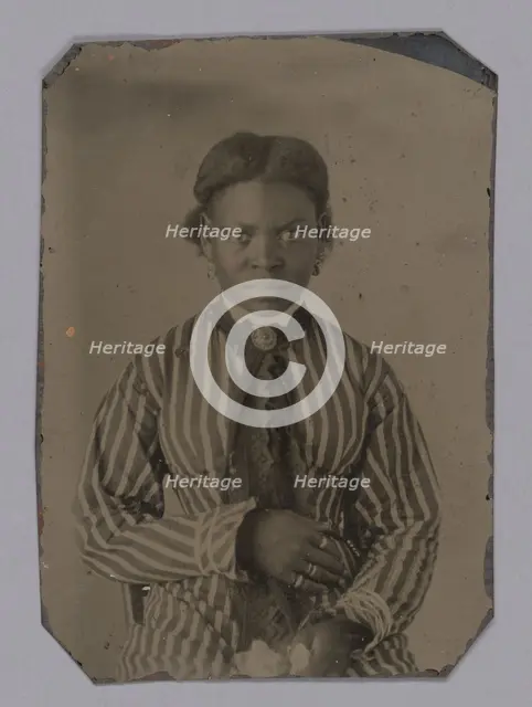Tintype of young woman in striped dress, Late 1860s. Creator: Unknown.