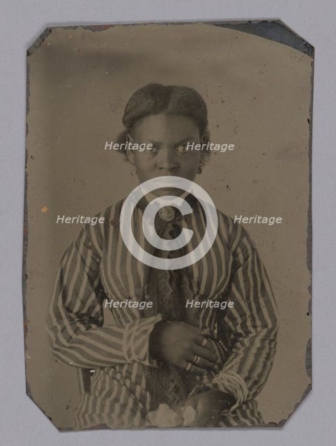 Tintype of young woman in striped dress, Late 1860s. Creator: Unknown.