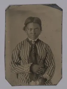 Tintype of young woman in striped dress, Late 1860s. Creator: Unknown