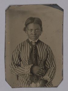 Tintype of young woman in striped dress, Late 1860s. Creator: Unknown