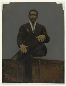 Tintype of a man wearing a suit with a pendant on the lapel, early 20th century. Creator: Unknown