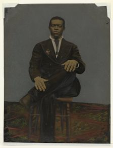 Tintype of a man wearing a suit with a pendant on the lapel, early 20th century. Creator: Unknown