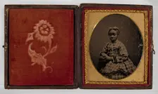 Tintype of a girl in a plaid dress, 1870s. Creator: Unknown