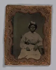 Tintype of a woman wearing a striped dress with flowers in her hair, 1855-1860s. Creator: Unknown