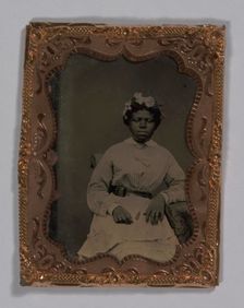 Tintype of a woman wearing a striped dress with flowers in her hair, 1855-1860s. Creator: Unknown