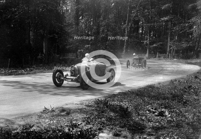 TP Cholmondeley-Tapper's Bugatti Type 37A leading a Frazer-Nash TT replica at Donington Park, 1930s. Artist: Bill Brunell.