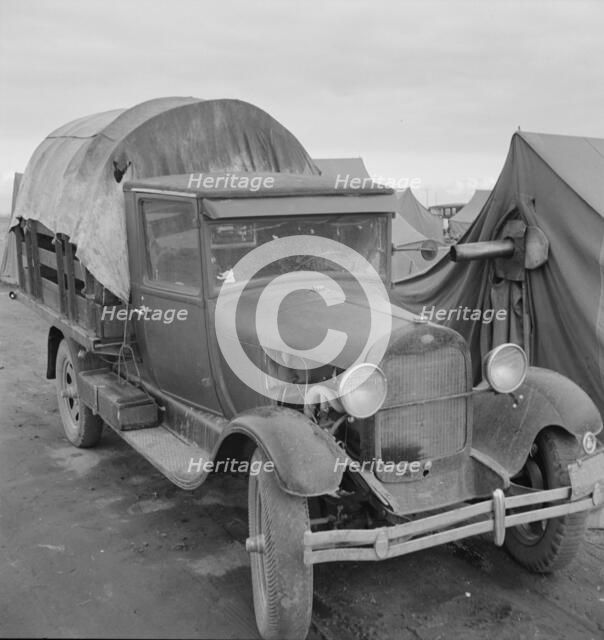 Truck, baby parked on front seat, FSA camp, Merrill, Klamath County, Oregon, 1939. Creator: Dorothea Lange.