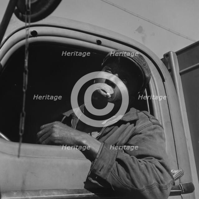 Truck driver for the Alaska Coal Company, Washington, D.C., 1942. Creator: Gordon Parks.