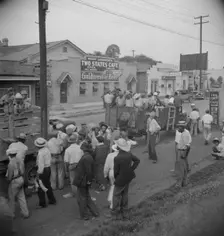 Truck loads of cotton hoers going from Memphis, Tennessee into Arkansas, 1937. Creator: Dorothea Lange