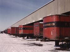 Truck trailers line up at a freight house to load and unload goods...C & NW RR, Chicago, Ill., 1942. Creator: Jack Delano