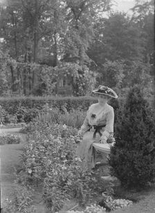 Truesdale, W., Mrs., standing in a garden, 1915 July 6. Creator: Arnold Genthe
