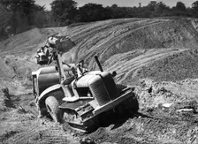 Tractor unit pulling an earth grading machine at a site near Rotherham, South Yorkshire, 1954. Creator: Michael Walters