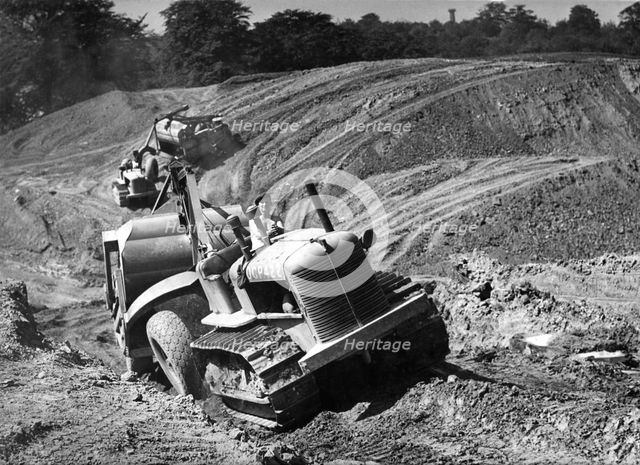 Tractor unit pulling an earth grading machine at a site near Rotherham, South Yorkshire, 1954. Artist: Michael Walters