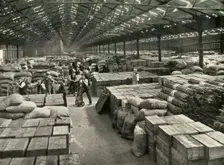 "Traffic and Merchandise Multiplied Century By Century" A Dock Transit Shed 1937. Creator: Unknown