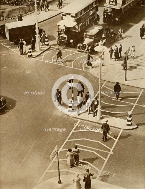 Traffic and pedestrians in Trafalgar Square, London, 1935.  Creator: Unknown.
