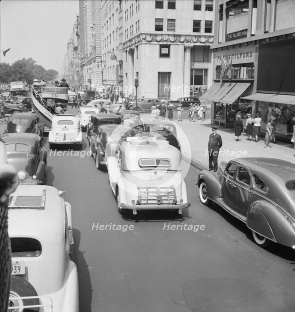 Traffic on Fifth Avenue approaching 57th Street on a summer afternoon, New York City, 1939. Creator: Dorothea Lange.