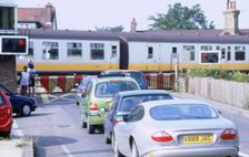 Traffic queue at level crossing in Brockenhurst, Hampshire